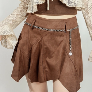 Detail of silver chain belt with sunburst pendant on brown suede irregular skirt
