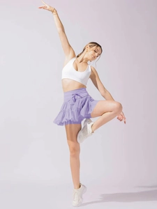 Detail of lavender pleated high-waisted skort showing flowy fabric and tie-up design