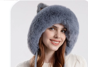 Close-up of grey knit hat with plush cat ears, warm faux fur lining, and chin straps