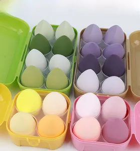 Set of macaron-colored makeup sponges in storage cases with drop and slanted shapes