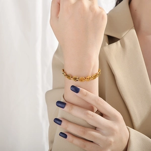 Golden titanium steel sunflower gear link bracelet for women on a model's wrist