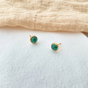 Detailed close-up of small round malachite stud earrings with 18K gold plated brass finish