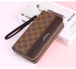 Close-up of brown vintage long zipper wallet with classic patterned texture and dark trim