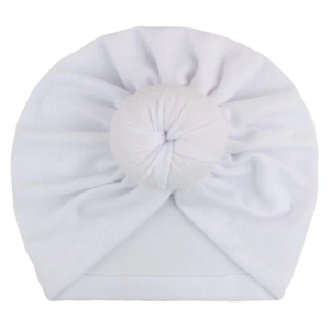 Close-up of pure white baby turban hat with a cute decorative donut knot detail