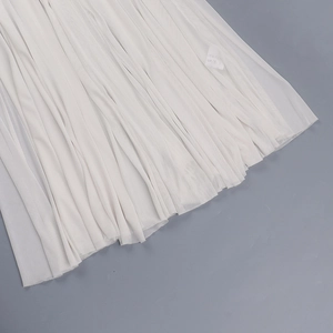 Detail view of multi-layered pleated white mesh fabric with light and translucent texture