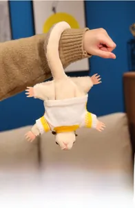Detail of soft plush sugar glider toy wearing a yellow and white knitted sweater