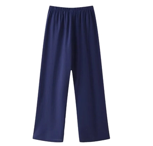 Detail view of navy blue wide-leg trousers with elastic waistband on white background