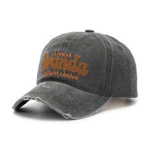 Detail of distressed brim and orange embroidery on vintage washed cotton baseball cap