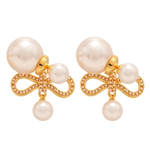 Elegant gold plated bow pearl earrings with high-gloss pearls on a white background
