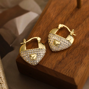 Elegant 18K gold-plated heart earrings with pave zircons on wooden display stand