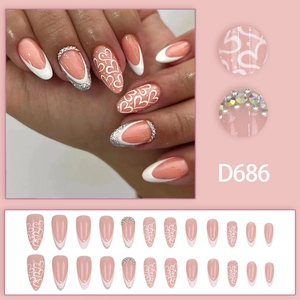 French gradient stiletto press-on nails with white heart designs and sparkling rhinestones