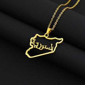 Detail shot of a gold Syria map pendant in stainless steel with Arabic calligraphy