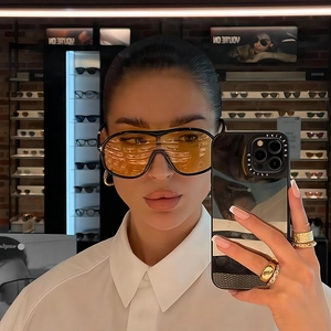 Fashionable oversized wrap-around sunglasses with yellow lenses and black frames