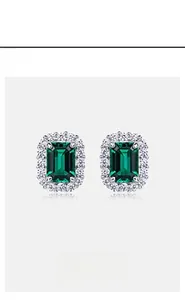 Detail of S925 silver emerald cut earrings with halo setting of white zircon stones