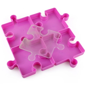 Pink puzzle piece shaped stackable storage trays with a clear lid for organizing small items