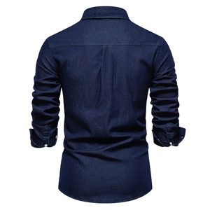 Rear view of dark blue denim shirt showing clean back yoke and central pleat detail