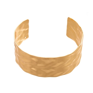 Irregular wide gold cuff bracelet with hammered texture and minimalist metal design