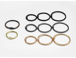 Detailed macro shot of metal loose-leaf binder rings in various colors and sizes