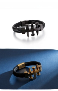 Macro shot of punk style braided leather bracelets with nail hardware and metal clasp