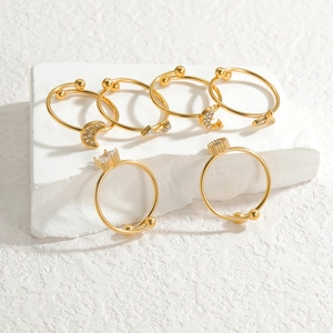 Set of minimalist gold rings with moon and star motifs and sparkling zircon stones