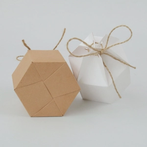 Detail of hexagonal kraft and white paper gift boxes with rustic jute twine bow
