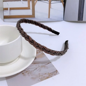 Detailed close-up of dark brown beaded twist headband on a clean white aesthetic surface