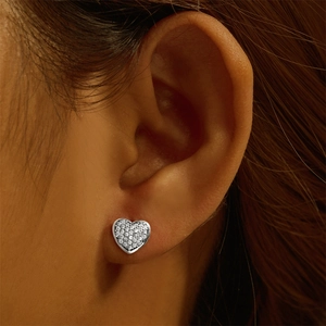 Close-up of heart-shaped S925 sterling silver stud earrings with pavé diamond setting