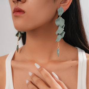 Model wearing green acrylic petal tassel earrings with gold chain for a vintage look