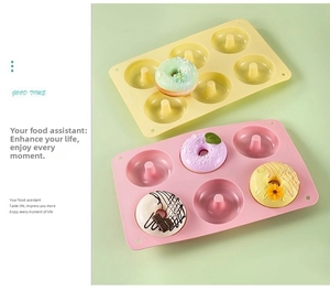 Close-up of flexible 6-cavity silicone donut baking molds in pink and yellow colors