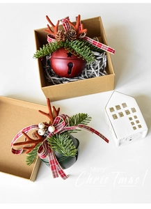 Macro detail of Christmas bell ornaments with antlers, pine cones, and festive ribbons