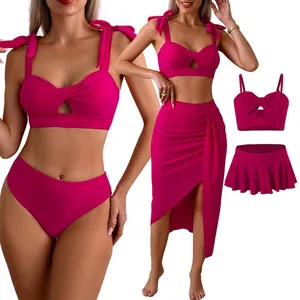 Three-piece rose red bikini set with bow straps and ruffled skirt for beach vacations
