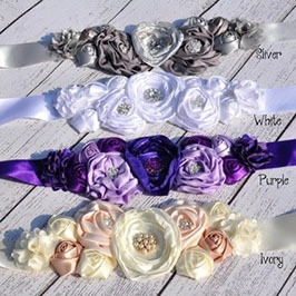 Close-up of handmade satin flower accessories with rhinestones in four elegant colors