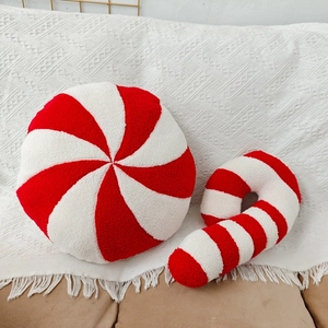 Close-up of red and white striped peppermint and candy cane plush Christmas pillows