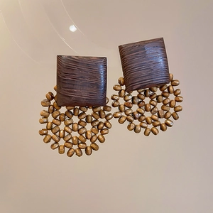 Detail of vintage geometric wooden drop earrings with brown rectangular studs and beads
