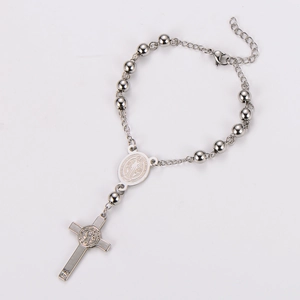 Detailed close-up of Saint Benedict medal and cross pendant on stainless steel rosary bracelet