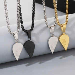 Detail of interlocking heart pendants in silver, gold and black with fingerprint textures
