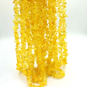 Macro shot of irregular natural yellow citrine stone chips for DIY jewelry making