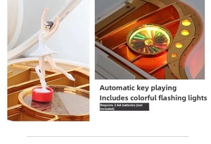 Close-up of piano music box with rotating ballerina, golden interior, and jewelry slots