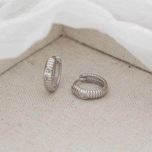 Detail of S925 silver hoop earring with marquise zircon and snake skin texture