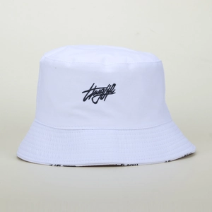 White cotton bucket hat with black embroidery and letter printed lining on a plain background