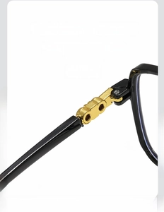 Macro detail of high-quality gold metal hinge on square black glasses frames