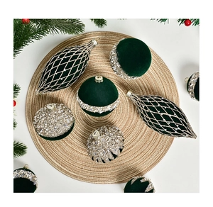 Close-up of dark green velvet Christmas ornaments with silver sequins and gold beads