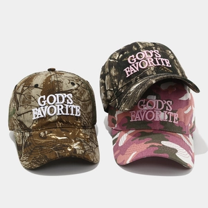 Detailed close-up of three camouflage baseball caps with 3D embroidery on front