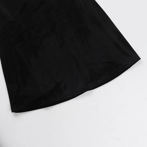 Detail shot of the black velvet fabric hem showing luxurious soft texture and material