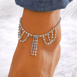 Macro view of crystal rhinestone fringe anklet featuring layered water drop pendants