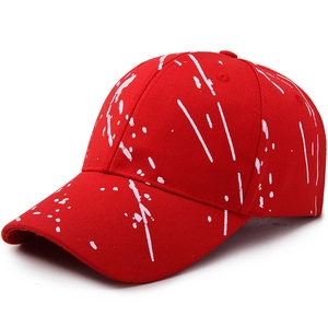 Red baseball cap with white paint splatter pattern for outdoor sun protection