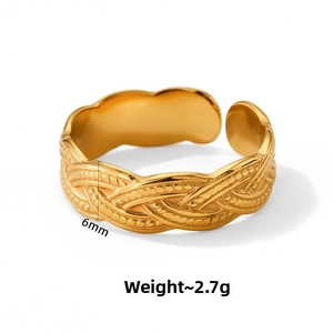 Detail of 6mm wide twisted woven gold ring showing weight and bright polished finish