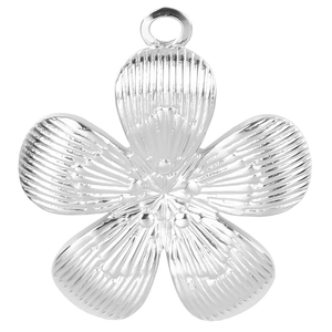 Macro detail of silver flower pendant in stainless steel with textured petal patterns