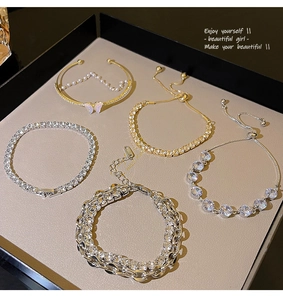 Close-up of luxury pearl and zircon bracelets with butterfly and floral designs