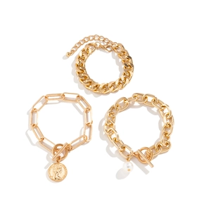 Detailed view of 3-piece gold chain bracelet set with coin and pearl charms
